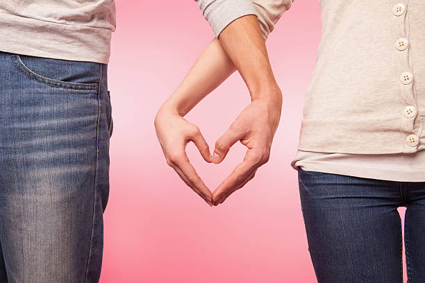 istock lwoman and man hands showing heart shape 536557005