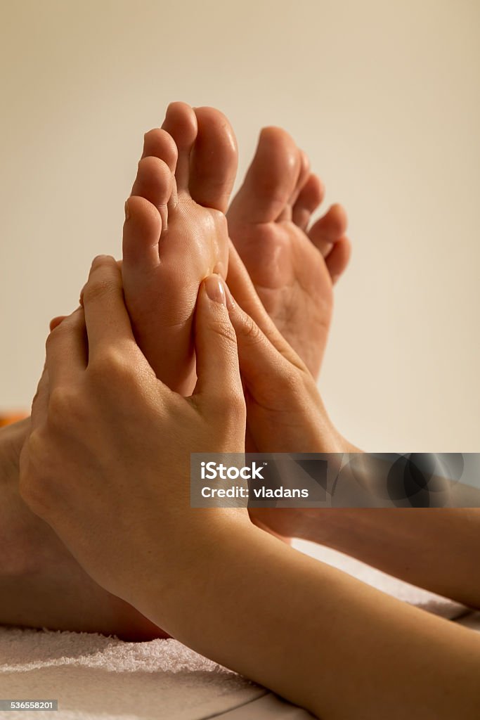 Foot Massage Woman receiving a foot massage at the health spa centre 2015 Stock Photo