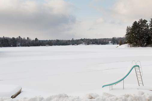 A water slide sits by a frozen lake in Kawartha lakes in Ontario.