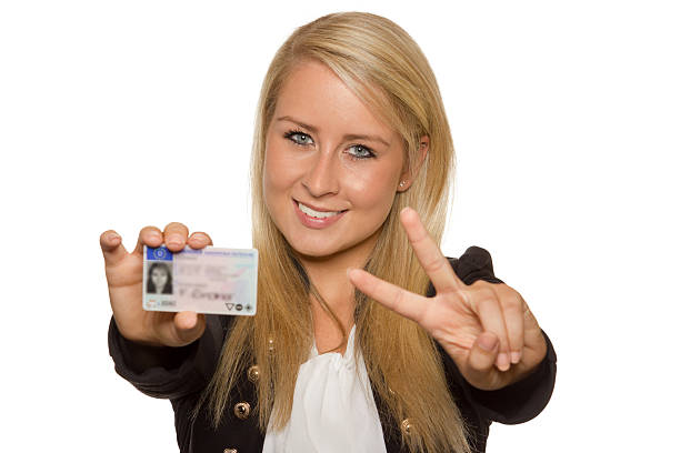 Young woman showing her driver's license stock photo