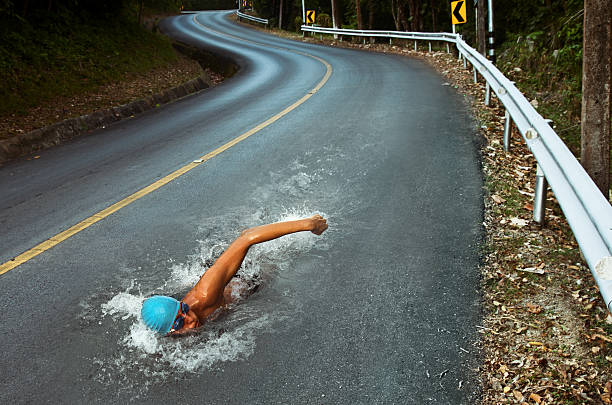 Strong Man Swim On Asphalt Road