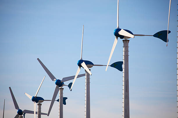 istock Green renewable energy concept - wind generator turbines on blue 536614871