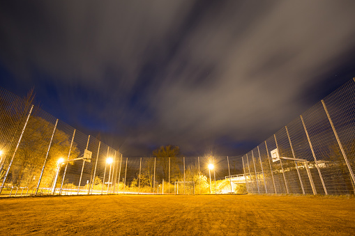 metal soccer court cage at night