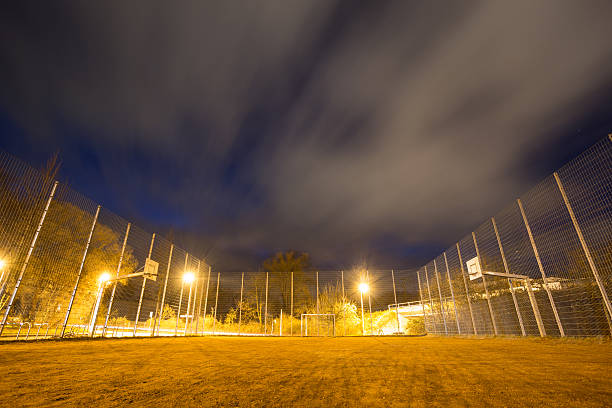 soccer court cage at night stock photo