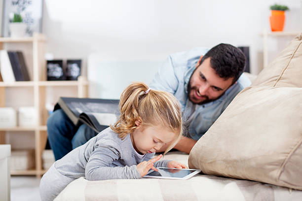 istock Little girl with her dad looking at tablet 536616899