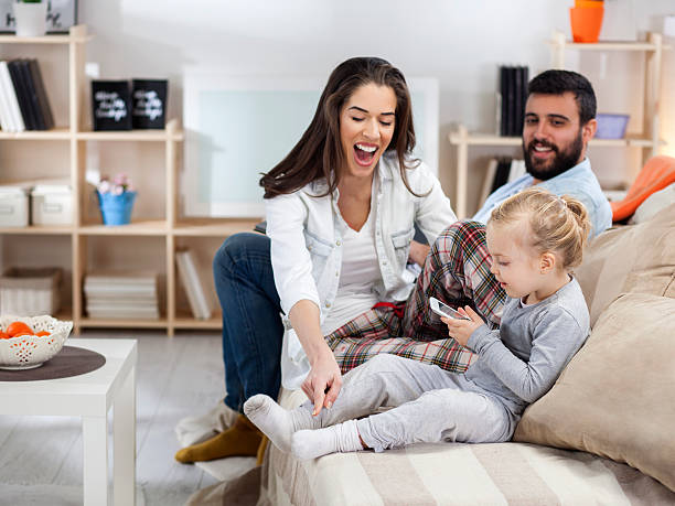 istock Mother and father teased daughter with digital tablet 536616975