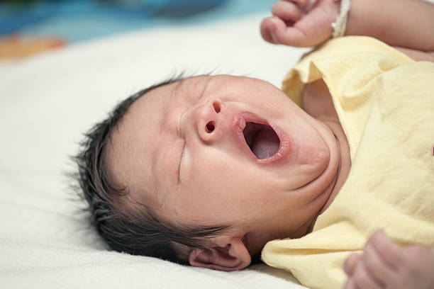 istock yawning newborn baby boy asleep on his bed 536629338