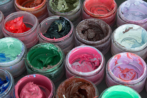 istock Oil paint in round containers background 536642612