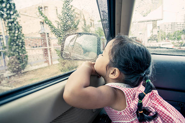 istock Child little girl looking the rain falling 536646808