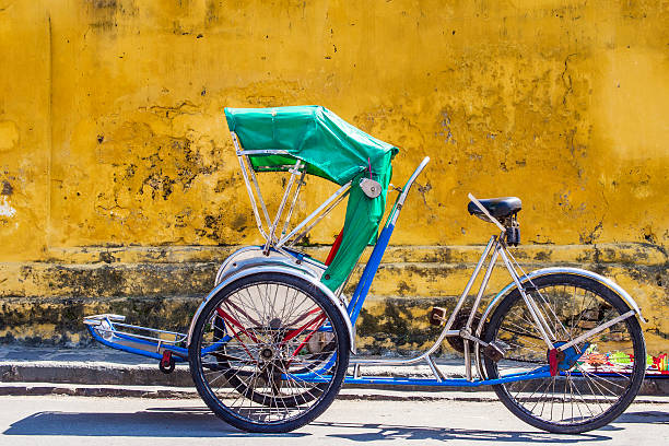 Tricycle in Hoi An Ancient Town, Central Vietnam Tricycle used to carry tourists around the UNESCO-listed Ancient Town of Hoi An, Central Vietnam. ho chi minh city stock pictures, royalty-free photos & images