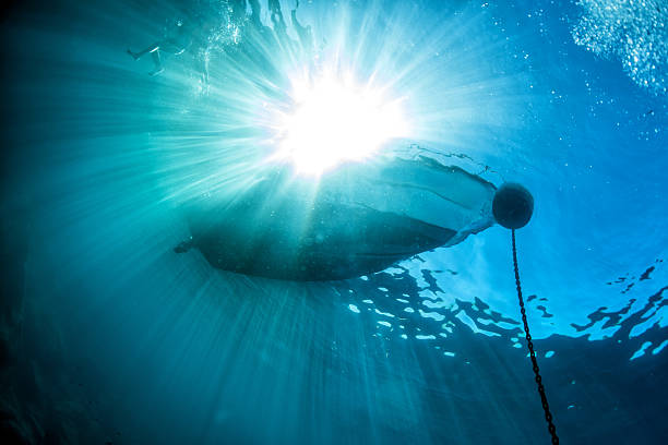 istock boat ship from underwater blue ocean with sun rays 536650132