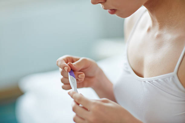 Am i pregnant Young woman with pregnancy test in hands ovulation stock pictures, royalty-free photos & images