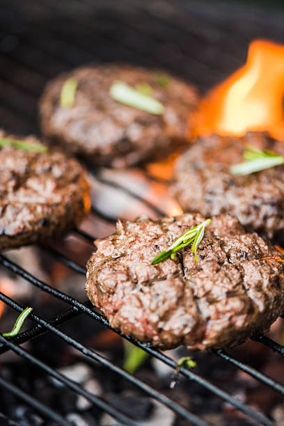 istock flames from bbq grill and beef burgers 536657186