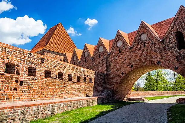 Gothic gate and medieval city walls in old town in Torun, Poland
