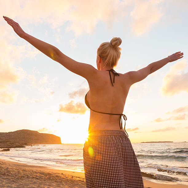 istock Free Happy Woman Enjoying Sunset on Sandy Beach 536667276