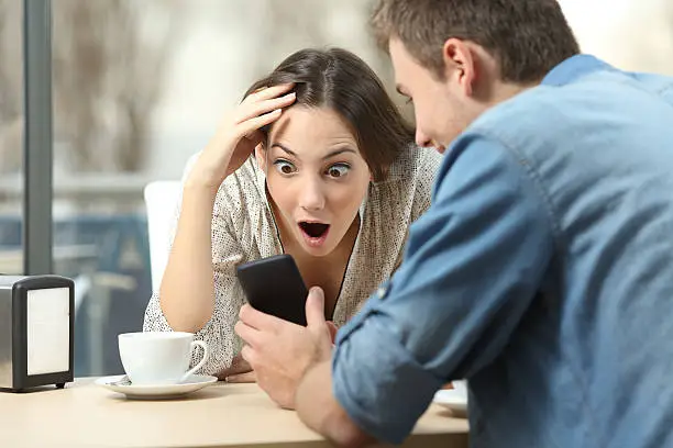 Photo of Surprised woman watching media in a smart phone