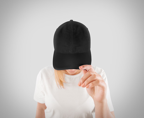 Blank black baseball cap mockup template, wear on women head, isolated, clipping path. Woman in gray hat and t shirt uniform mock up holding visor of caps. Cotton basebal cap design on delivery guy.