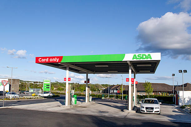 Asda - Petrol Station Swansea, UK: May 22, 2016: A car is stopped at a petrol station at an Asda supermarket. Asda Stores Limited is an American-owned, British-founded supermarket retailer, headquartered in Leeds, West Yorkshire.  asda photos stock pictures, royalty-free photos & images