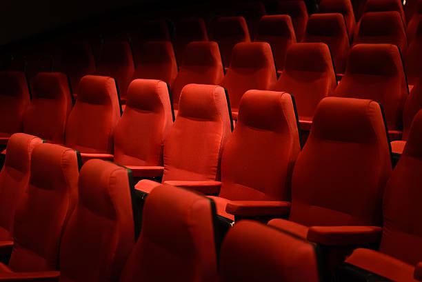 istock Empty red cinema chairs, red seats. Dark tone 536669968