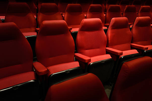 istock Empty red cinema chairs, red seats. Dark tone 536670008