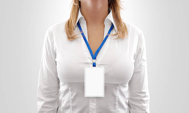 Woman wear blank white vertical badge mockup, stand isolated. Woman wear blank white vertical badge mockup, stand isolated. Name tag on neck and chest. Person identity label. Women in shirt uniform with empty id card mock up.  Bussinesswoman pass design. name tag stock pictures, royalty-free photos & images