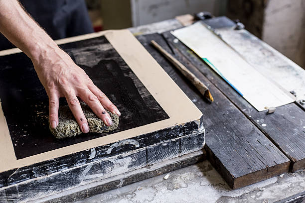istock Close up of male lithograph worker using a sponge 536674188