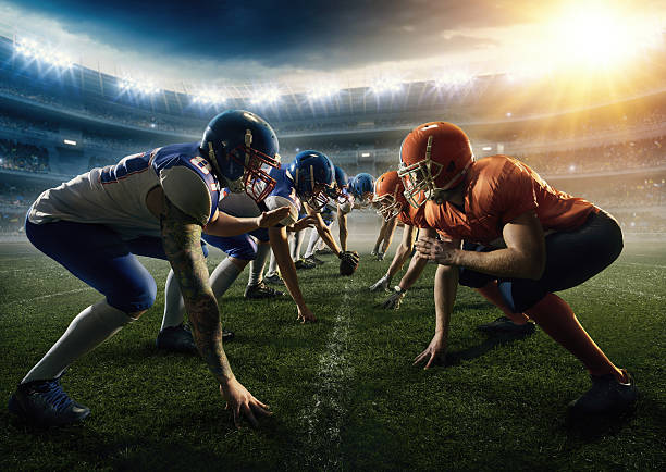 American football teams head to head American football teams stay head to head  on a generic outdoor football stadium under a cloudy sky with bright sun. The players wear unbranded professional clothes. confrontation stock pictures, royalty-free photos & images