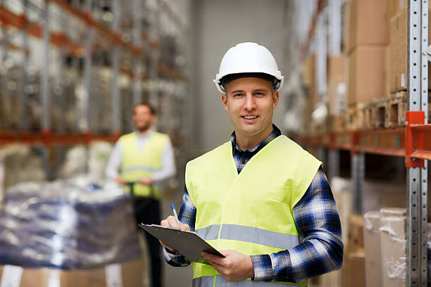 istock man with clipboard in safety vest at warehouse 536676110