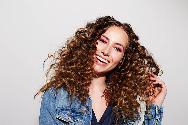 Smiling young model with curly hair, portrait Smiling young model with curly hair, portrait curly hair stock pictures, royalty-free photos & images