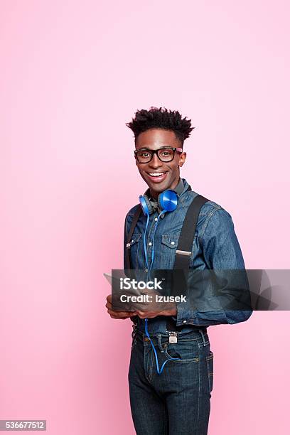Friendly Afro American Guy In Fashionable Outfit Holding Digital Tablet Stock Photo - Download Image Now