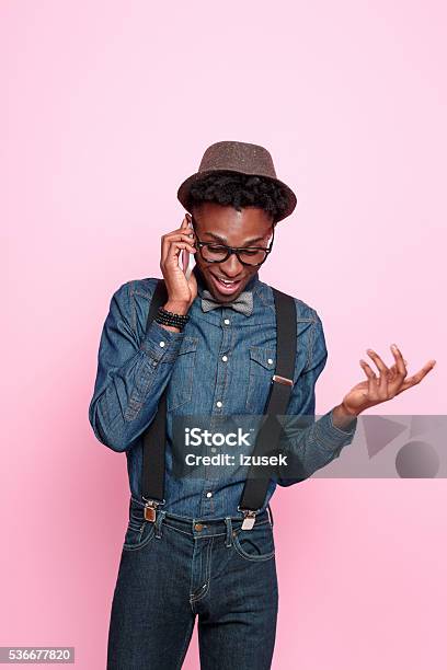 Funky Afro American Guy Talking On Smart Phone Stock Photo - Download Image Now - Discussion, Men, Colored Background
