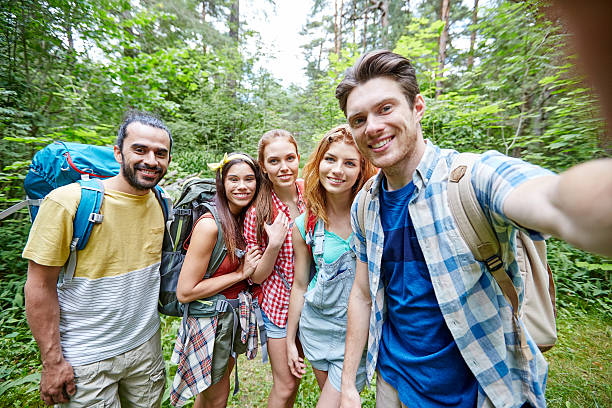 istock friends with backpack taking selfie in wood 536678292
