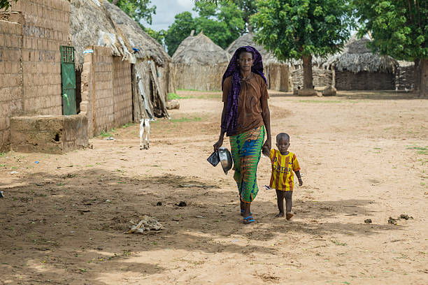 Young Senegalese woman walking with her child stock photo