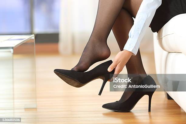 Businesswoman Taking Off Shoes Stock Photo - Download Image Now - High Heels, Getting Dressed, Women