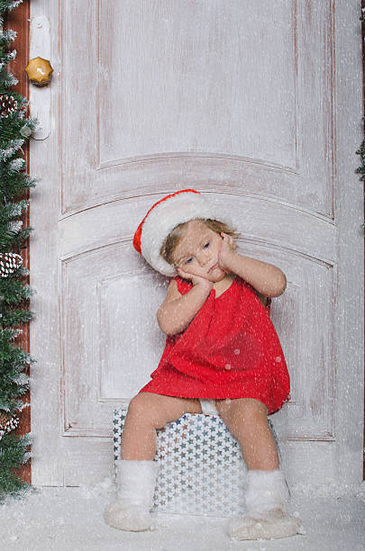istock Child dressed as Santa is sitting on gifts 536681167