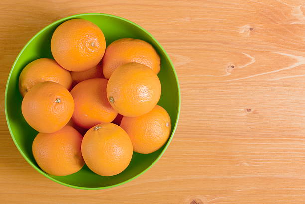 istock Beautiful ripe oranges on a yellow table 536681305