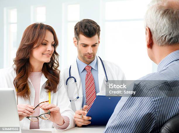 Medical Team With Elderly Patient Stock Photo - Download Image Now - 2015, Adult, Analyzing