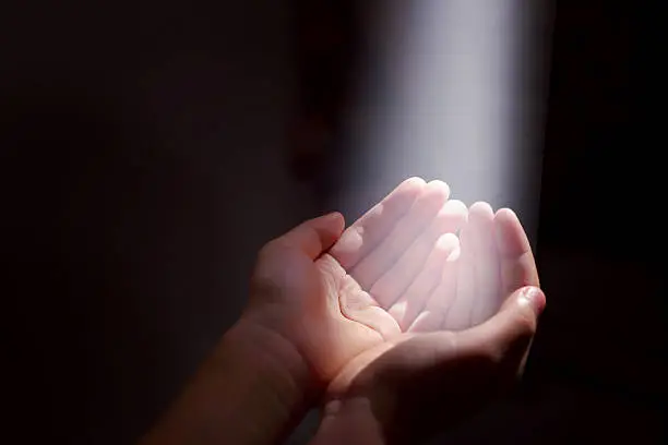 Photo of light beam and hands