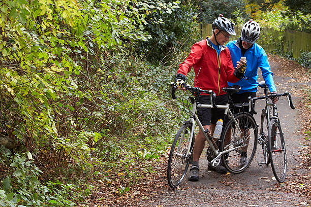 istock Two  Male Cyclists On Ride Looking At Mobile Phone App 536681685
