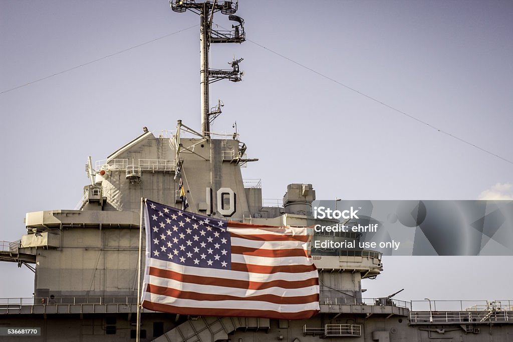 USS Yorktown And American Flag Mount Pleasant, South Carolina, USA - February 8, 2015: The bridge of the retired aircraft carrier USS Yorktown and American Flag in Patriots Point, South Carolina. US Navy Stock Photo