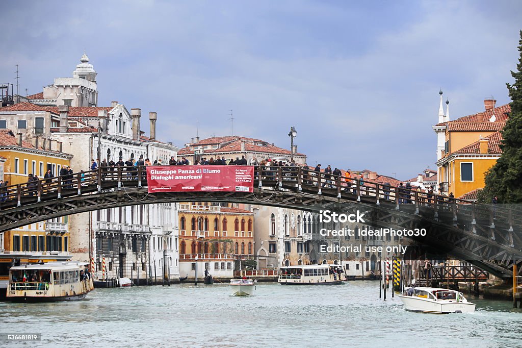 Dell Academy Bridge Venice, Italy - February 15, 2014: People walking on the Ponte dell Accademia bridge  in Venice, Italy. Ponte dell Accademia is one of the four bridges on grand canal in Venice. 2015 Stock Photo