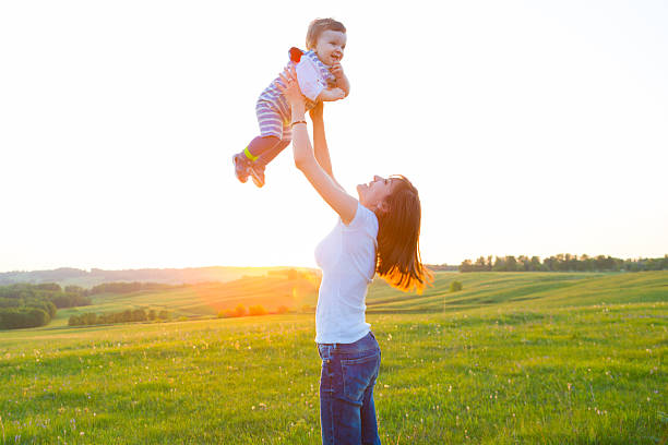 istock Mother and her child playing in spring field 536682208