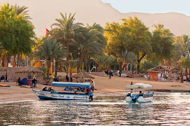 Aqaba, Jordan - November 20, 2010: Jordanian boatmen waiting for tourists at November 20, 2010 in the harbor of Aqaba, Jordan