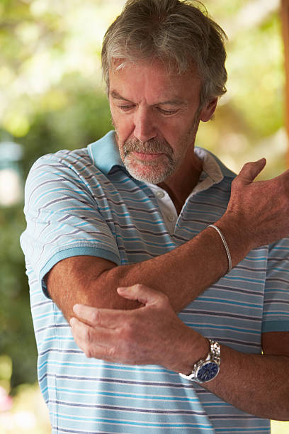 istock Mature Man Suffering From Painful Elbow At Home 536683515
