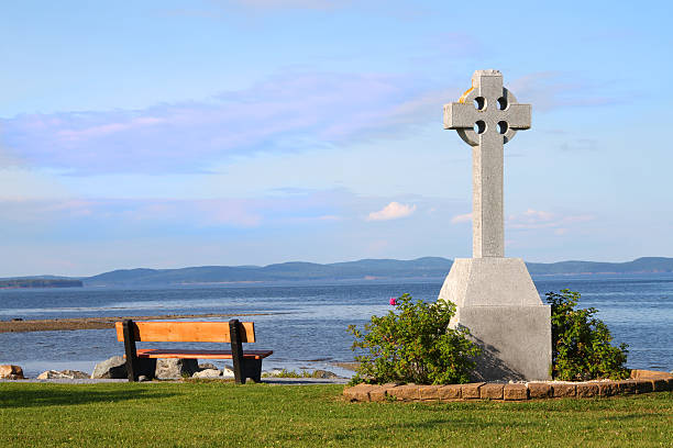 istock Bench and Celtic Cross by ocean 536683789