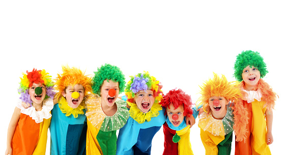 Group of happy children in clowns costumes
