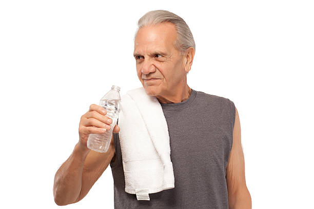 istock Senior man with water bottle and towel 536684301