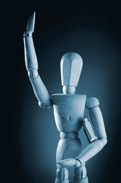 istock Wooden man holding book. 536684877