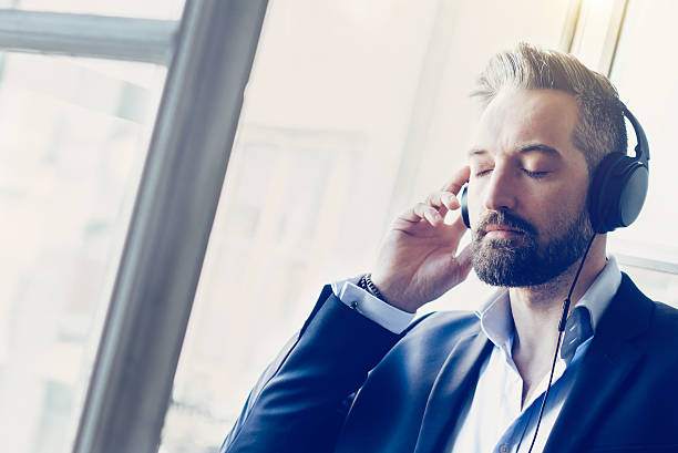 istock handsome bearded business man with headphones at window 536684910