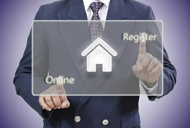 Well dressed businessman touching Register and online words on virtual Screen.